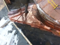 seaming a copper roof into a round valley